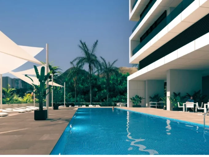 Swimming pool and sunbathing area at Slim Tower Benidorm